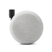 Round gray fabric speaker with black cylindrical component on a white background