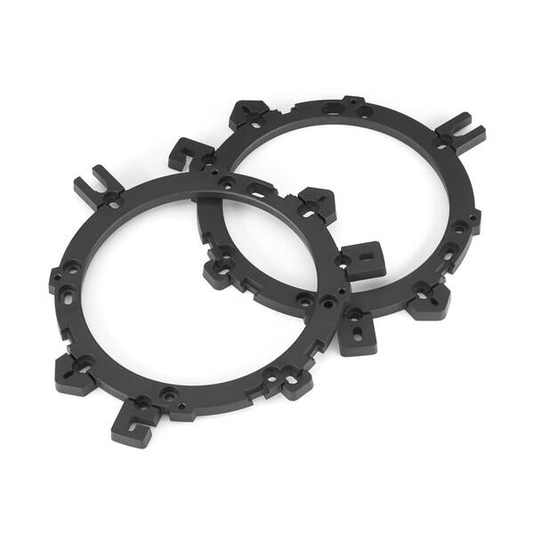 Two black metal ring components on a white background