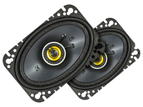 Pair of car speakers with black grills and yellow centers on a white background