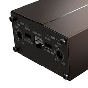 Close-up of the rear panel of a dark brown metal electronic device, showing input and output jacks with labels such as FRONT, SIGNAL INPUT, REAR, and gain settings.