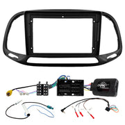 Car stereo dashboard frame kit with wiring harnesses and an electronic control module on a white background.