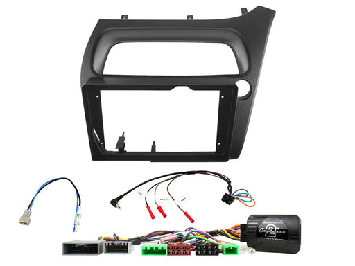 Car stereo dashboard console adapter frame kit with wiring harnesses and connectors on a white background.