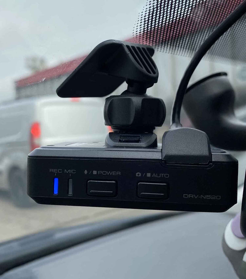 Kenwood DRV-N520 dash camera with HDR Super HD recording GPS and G sensor mounted on car windshield for driving safety