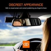 Car interior with a rearview mirror and a small screen on the dashboard, with text about discreet appearance.