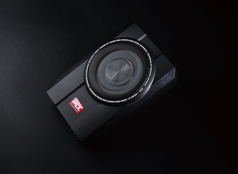 Black subwoofer with a visible brand logo on a dark background