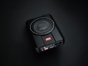 Black subwoofer with visible brand logo on a dark background