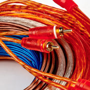 Coiled audio cable with red and gold RCA connectors on a white background