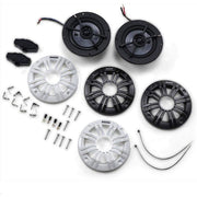 Set of car speakers with mounting hardware on a white background