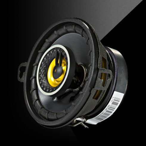 Car speaker with yellow center on a black background