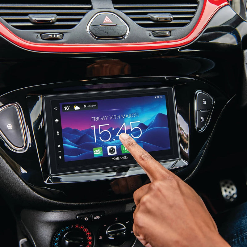 Person interacting with a car's touchscreen display.